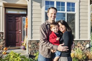 Boise Home Inspectors couple with their son standing in front of their house