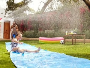 family-sliding-in-lawn
