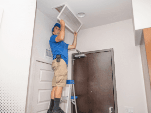 Home inspector checking air vent in a Boise, ID home during an inspection.
