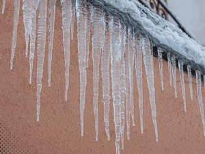 Icicles hanging from a roof in Boise, ID, indicating potential insulation or ventilation issues.