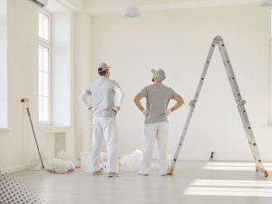 Two workers assessing an interior room in a Boise, ID home before renovation during a home inspection.