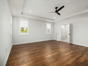 Empty bedroom with hardwood floors and ceiling fan in a Boise, ID home during inspection.