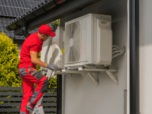 Technician inspecting outdoor HVAC unit at a Boise, ID home during maintenance inspection.