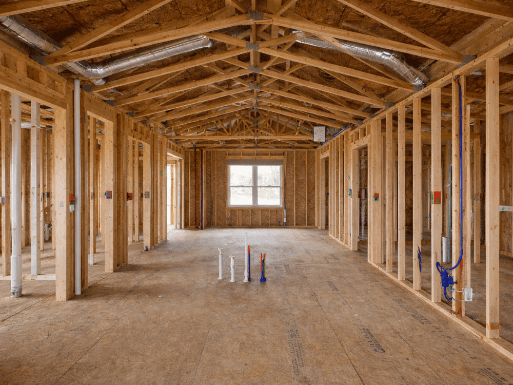 Interior of a new construction home during pre-drywall inspection, showing framing and plumbing in Boise, ID.